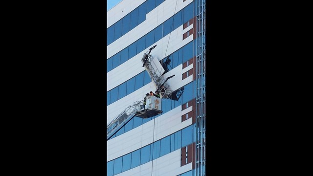 Window washers rescued from building