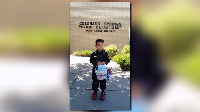 Kid is cop costume thanks officers