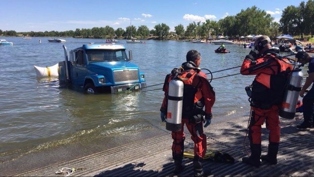 Truck and boat submerged at reservoir