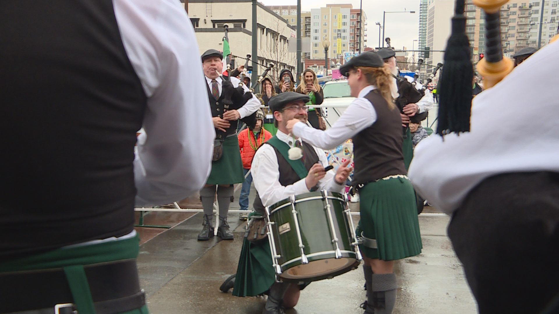 Bagpiper proposes during parade
